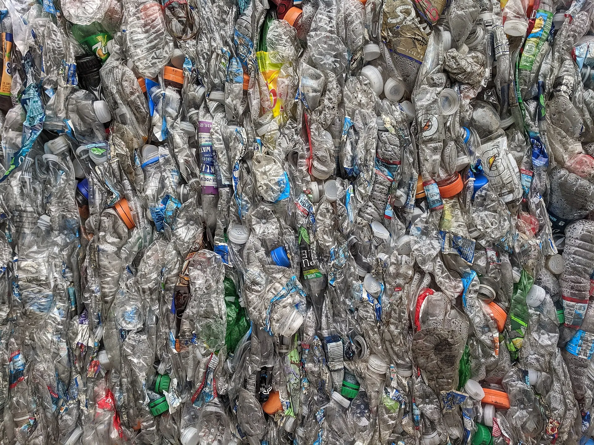 Bales of crushed PET plastic bottles at a recycling facility - At Home With the Refill Generation That Still Buys Bottles