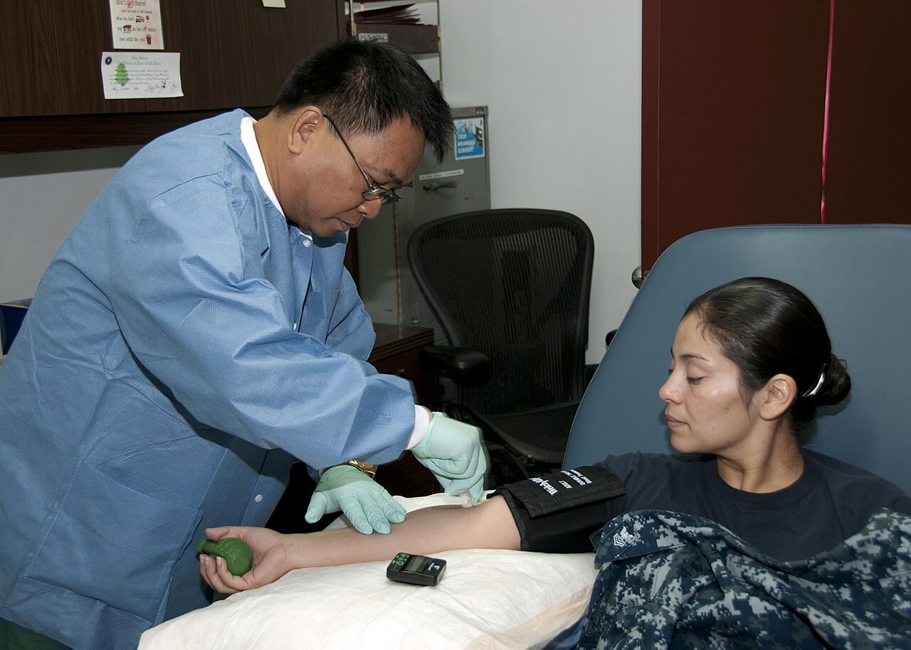 Phlebotomist drawing a blood sample from a patient