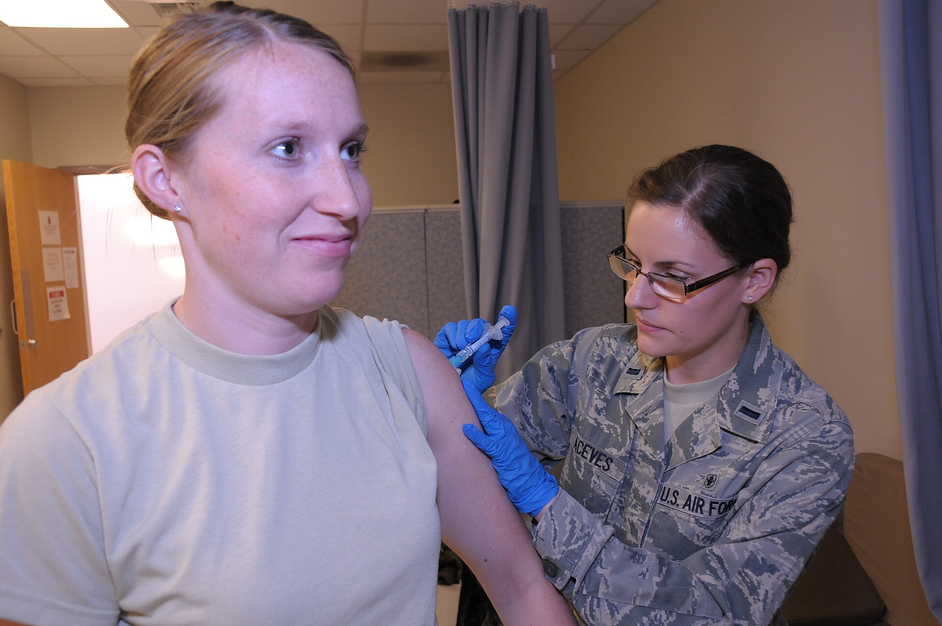 A clinician preparing a measles vaccine dose in a clean medical setting